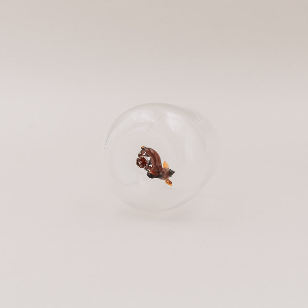 Trinkglas von unten fotografiert, zeigt die Rehfigur in liegender Position – Fokus auf das filigrane Design.