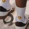 Weiße Kindersocken mit gelbem Smiley an der Ferse