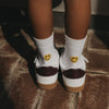 Weiße Smiley Socken für Kinder mit gelbem Motiv an der Rückseite