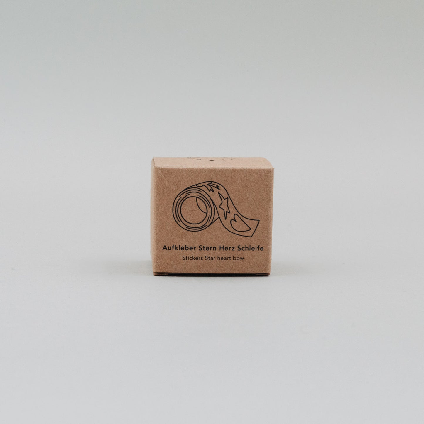 Kartonverpackung der goldenen Aufkleberrolle mit Motivdarstellung Stern, Herz, Schleife
