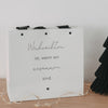 Detail Geschenktüte Weihnachten mit schwarzer Schleife und Papierstruktur